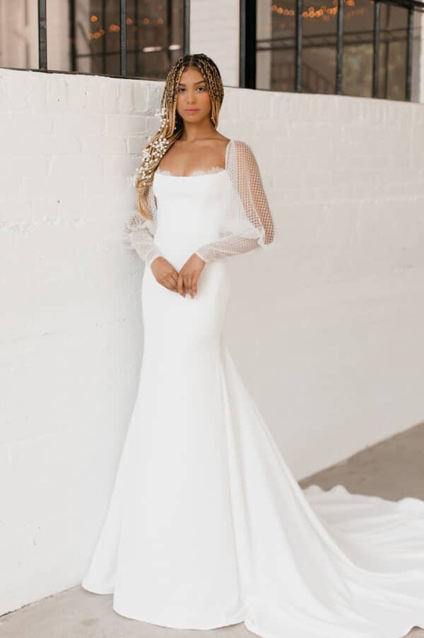 Tara LaTour Aster: Romantic stretch crepe fit-and-flare bridal gown featuring Juliet sleeves and a dramatic cathedral train, available at Love and Lace Bridal Salon in Orange, CA
