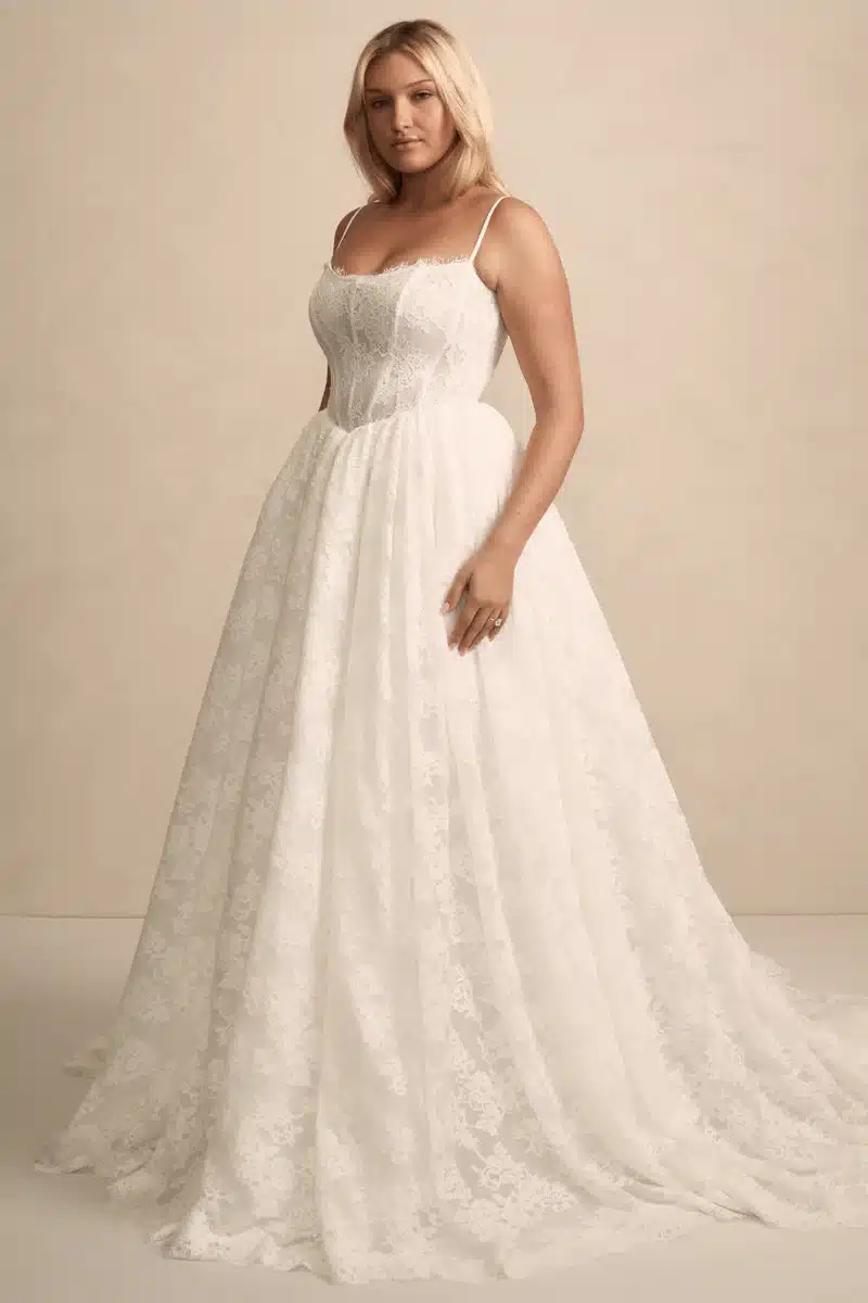 Flattering Prim plus-size wedding dress by Made with Love Bridal with basque waist bodice, internal boning, and flowing skirt that moves like a dream - available at Love and Lace Bridal OC.
