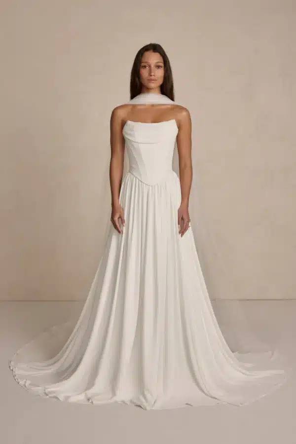 Tate by MWL Bride: A modern minimalist wedding dress featuring a structured Duchess Satin cowl-neck bodice and a flowing chiffon skirt, available at Love and Lace Bridal Salon in Orange, CA