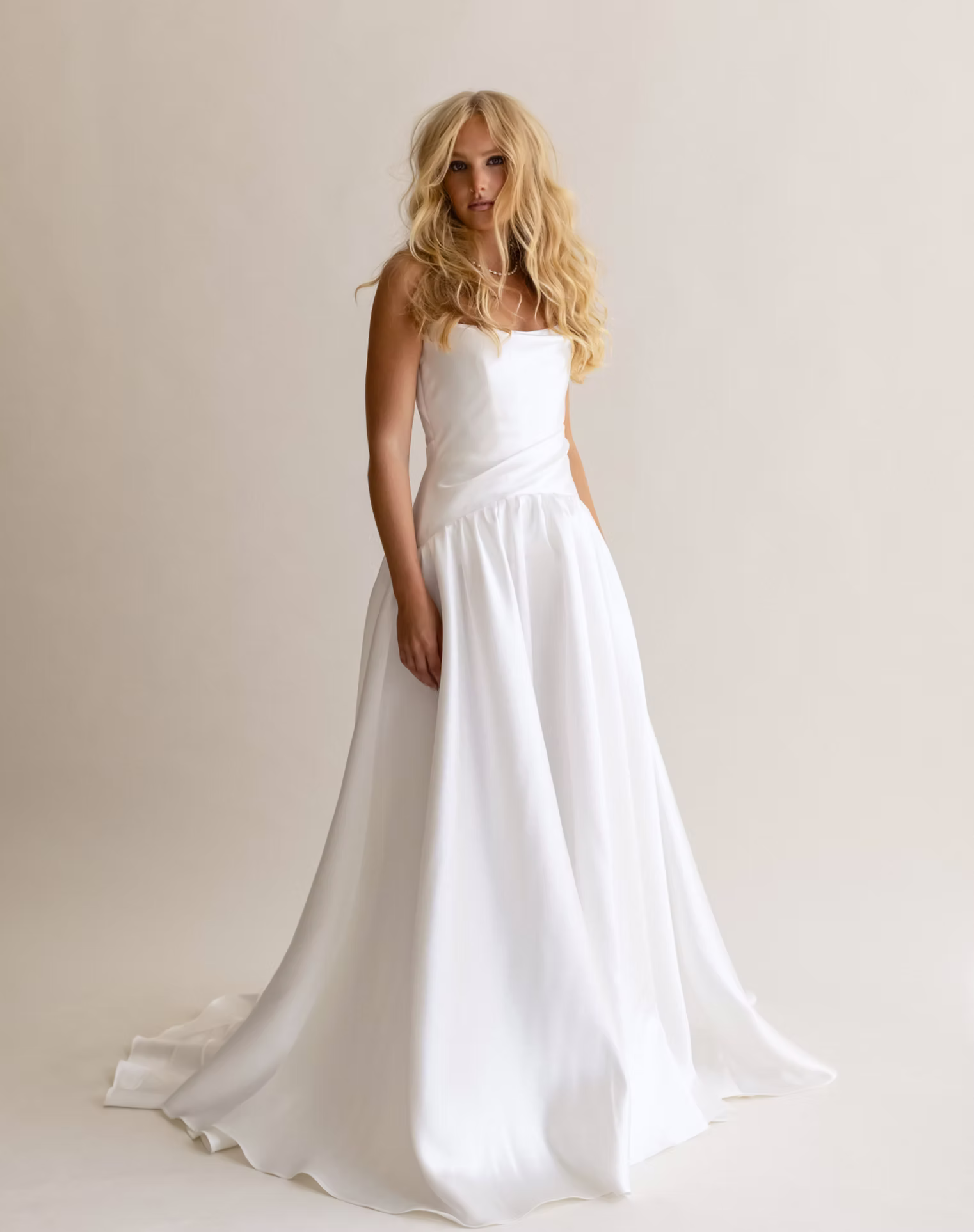 Leo by Anais Anette Bridal is a regal wedding gown with a dramatic drop waist and voluminous skirt, carried by Love and Lace Bridal Salon, Orange County.