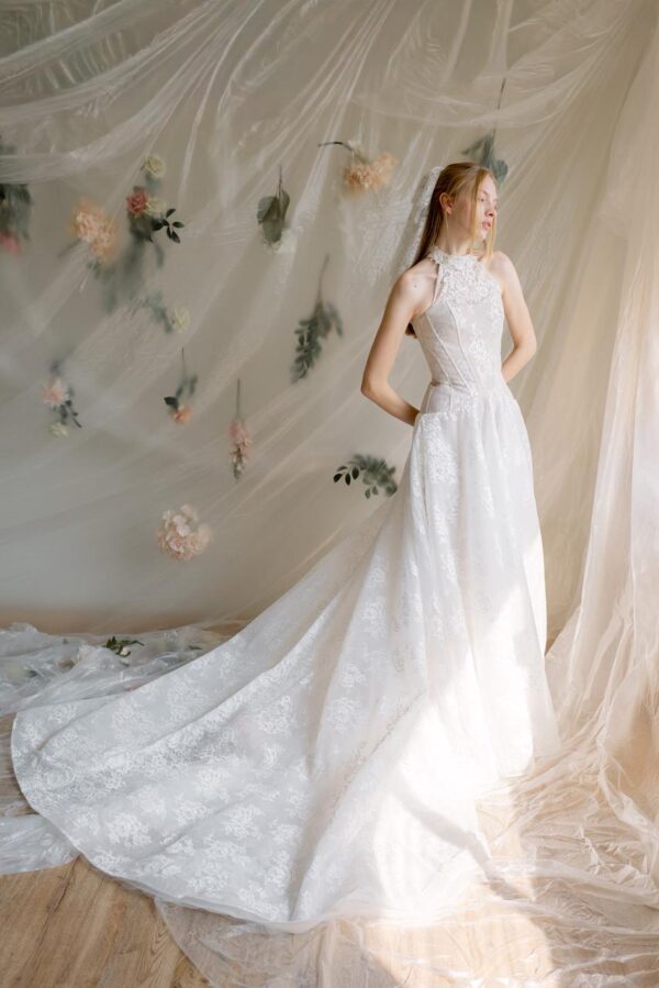 Vivianna romantic wedding dress by Guardiola Bridal at Love and Lace Bridal Salon in Orange, CA, featuring a structured strapless bodice, delicate floral embroidery, and a voluminous pleated skirt.