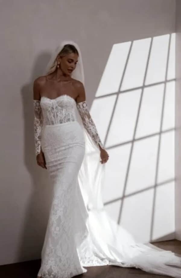 Winnie wedding dress by MWL Bride (formerly Made with Love Bridal) in ivory lining, featuring a sheer lace corset bodice and matching sleeves available at Love and Lace Bridal Salon in Orange, CA.