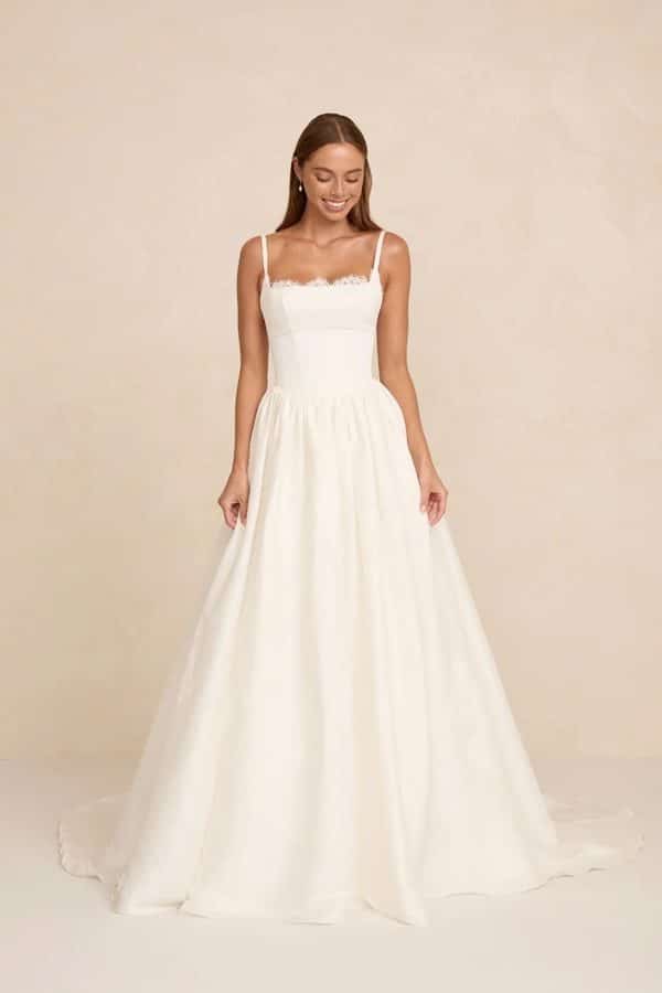 Adeline wedding dress by MWL Bride (Made with Love Bridal) in Mikado and silk linen featuring a structured Prim lace bodice and flowing skirt at Love and Lace Bridal Salon in Orange, CA.