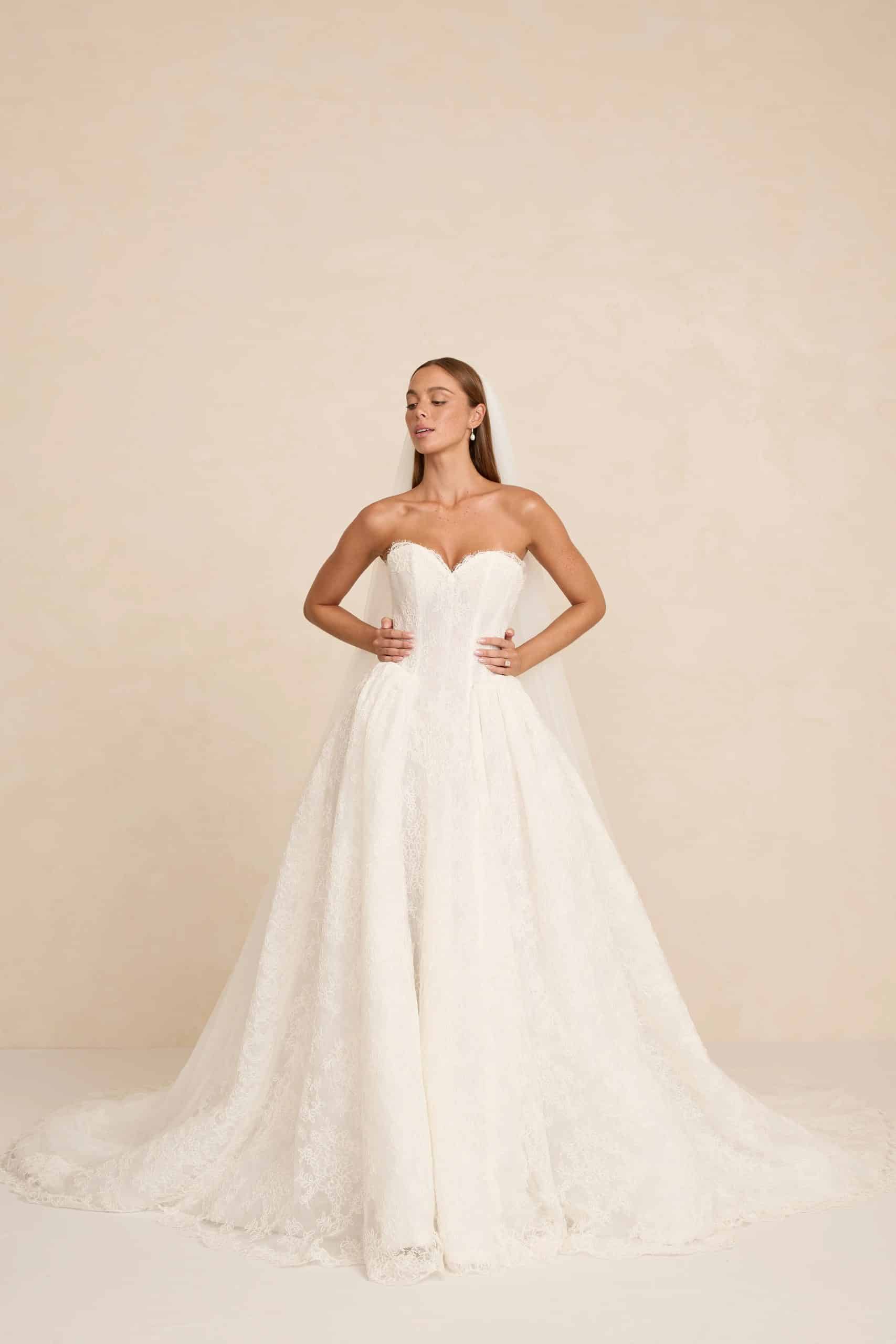 Rue wedding dress by MWL Bride (Made with Love Bridal) featuring a modern basque waist (A-line silhouette) with a sweetheart neckline, structured boning in Chantilly lace, available at Love and Lace Bridal Salon in Orange, CA.